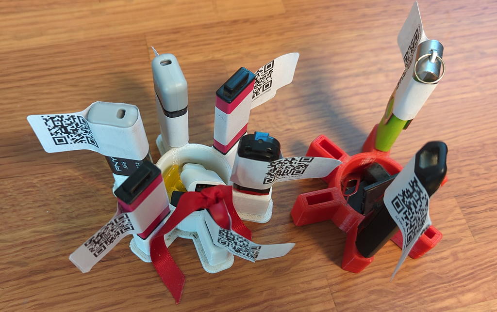 thumb drives in a carousel each with a QRazy.fun flag-style label